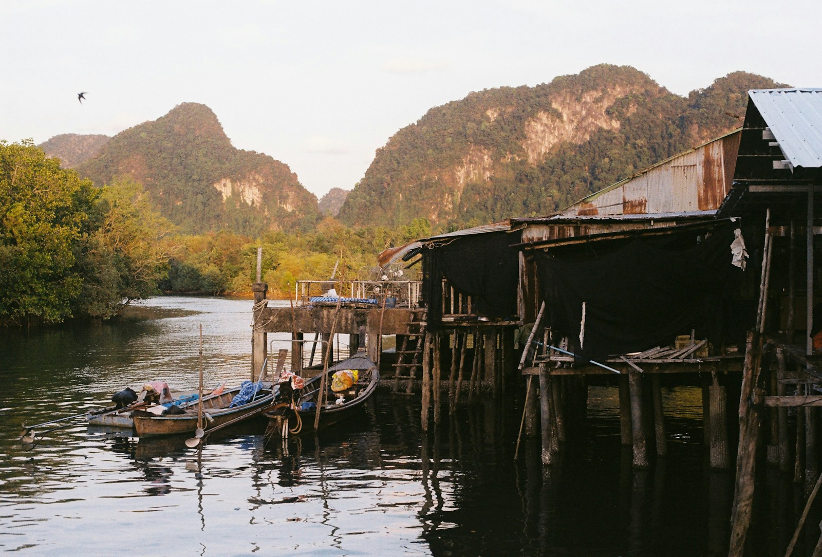 a dock with boats and a building on it