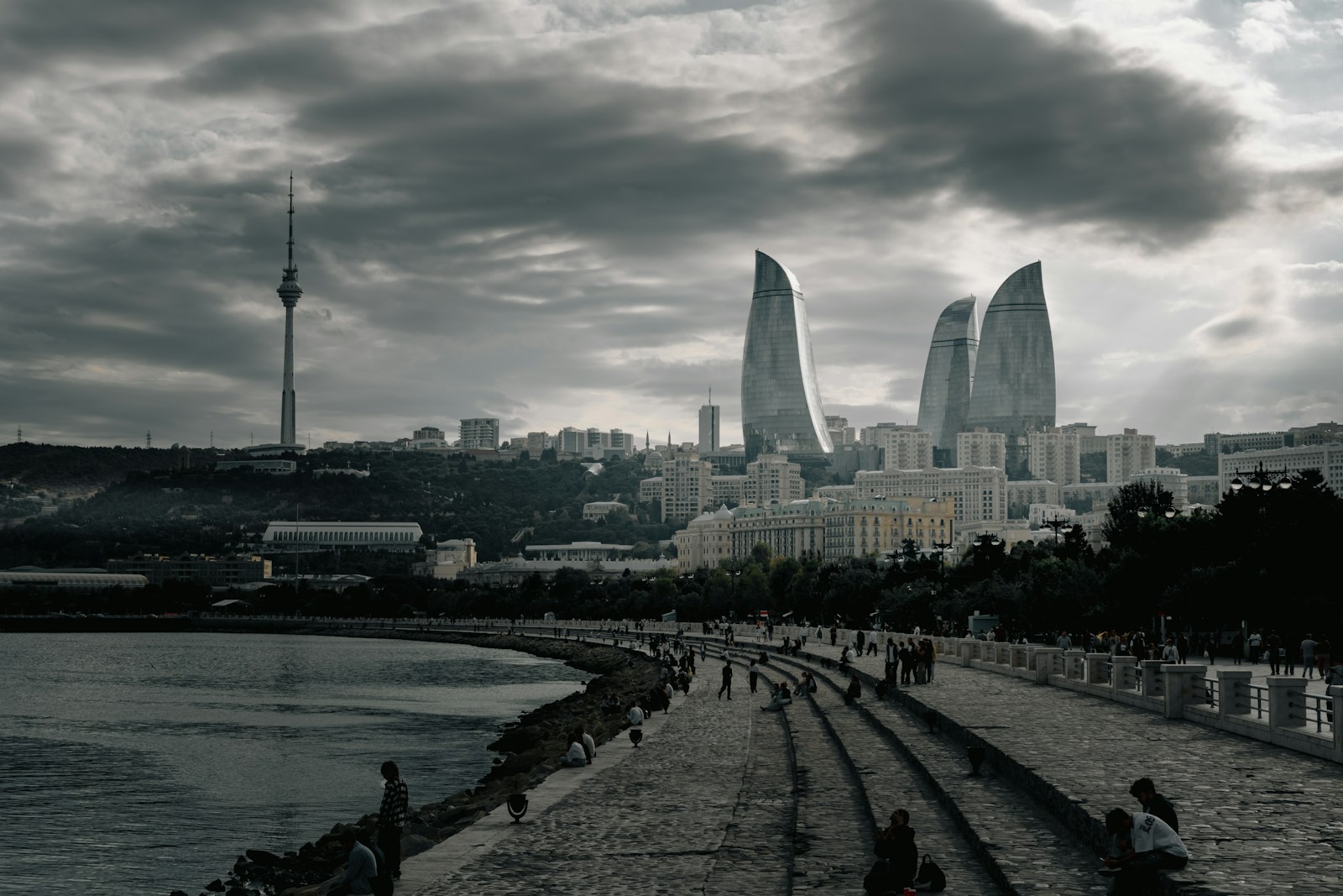 Modern city skyline with flame-shaped buildings and tower.