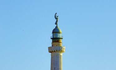 brown and green tower under blue sky during daytime