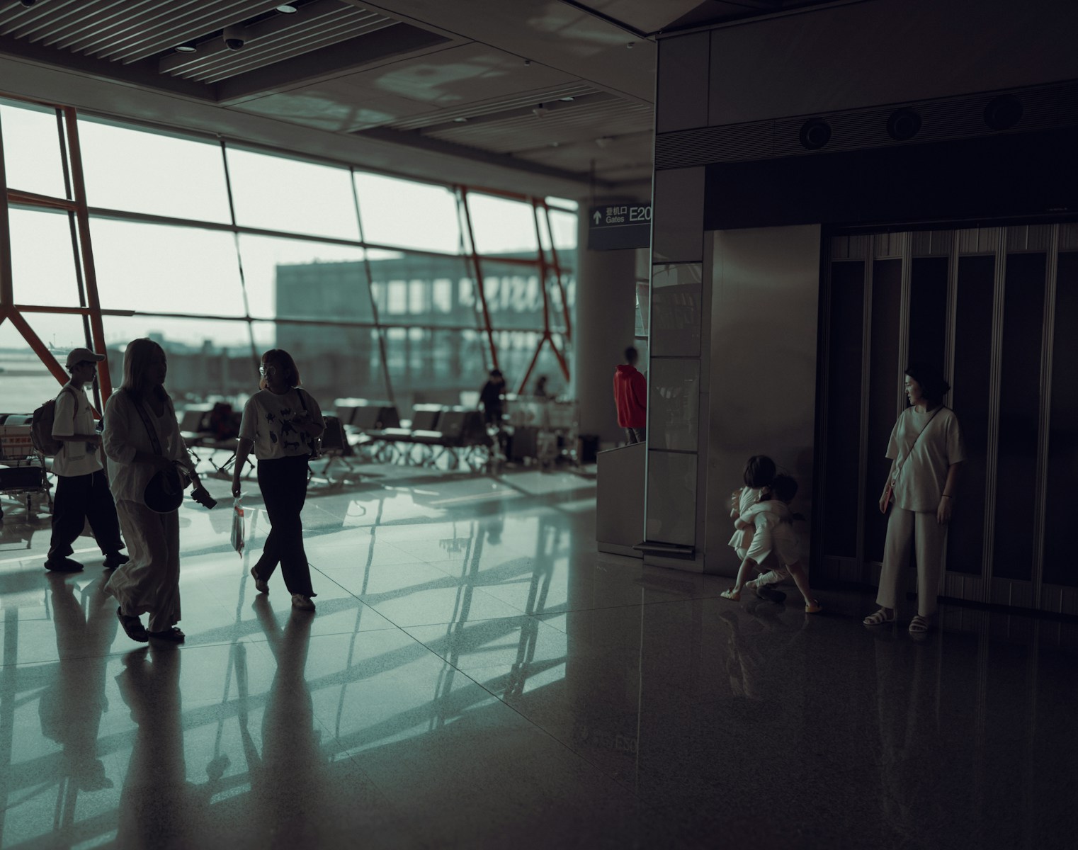 A group of people walking through an airport