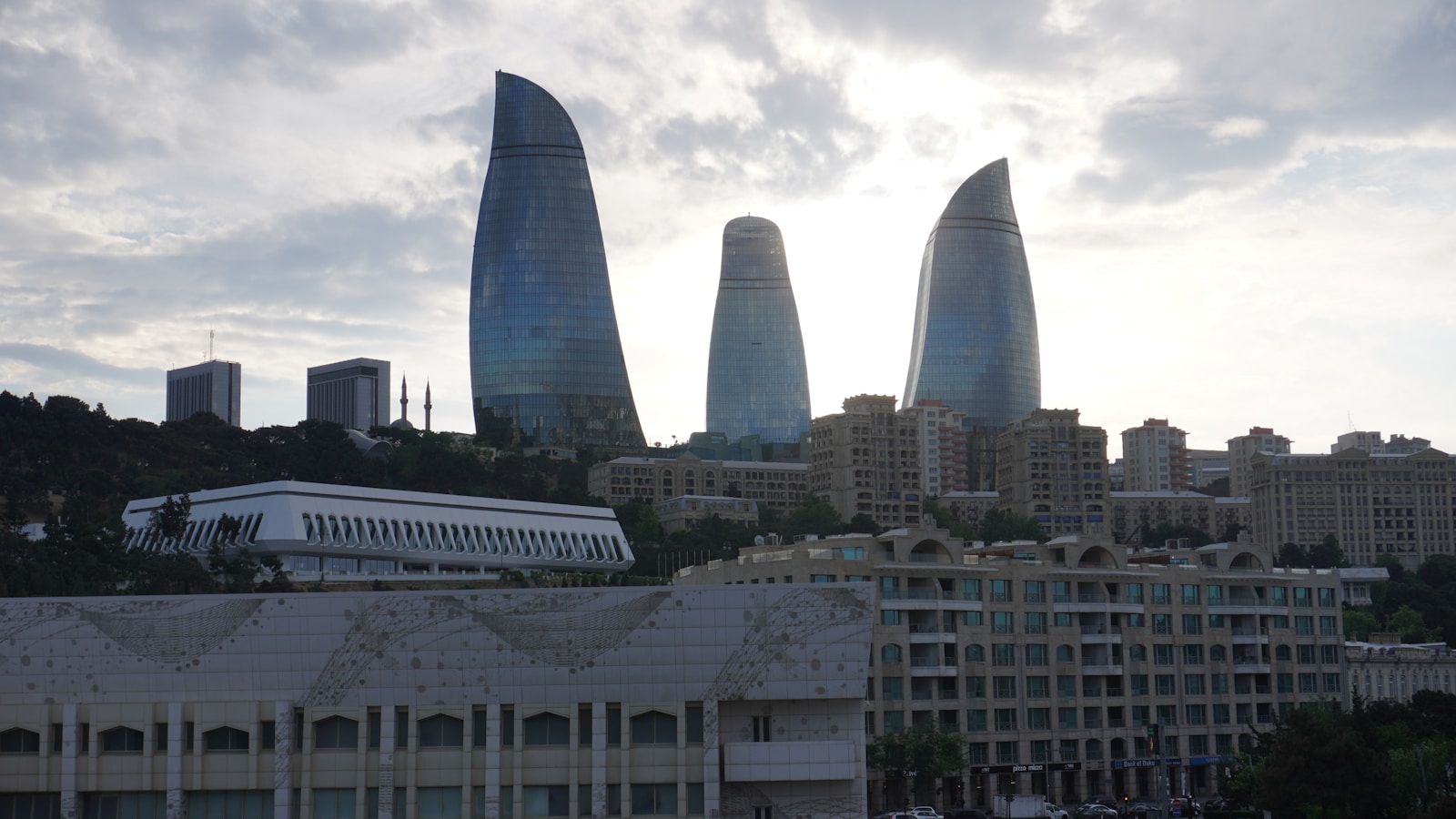 The flame towers illuminate the city skyline.