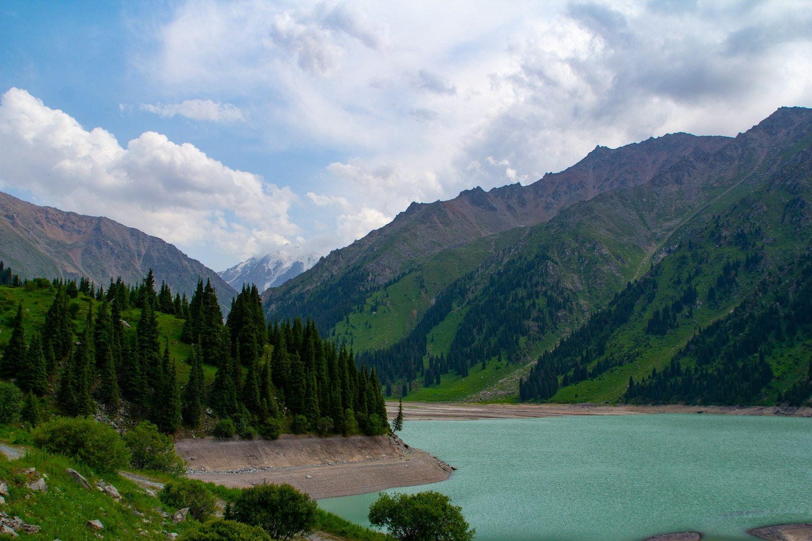 Mountains and a lake under a cloudy sky.